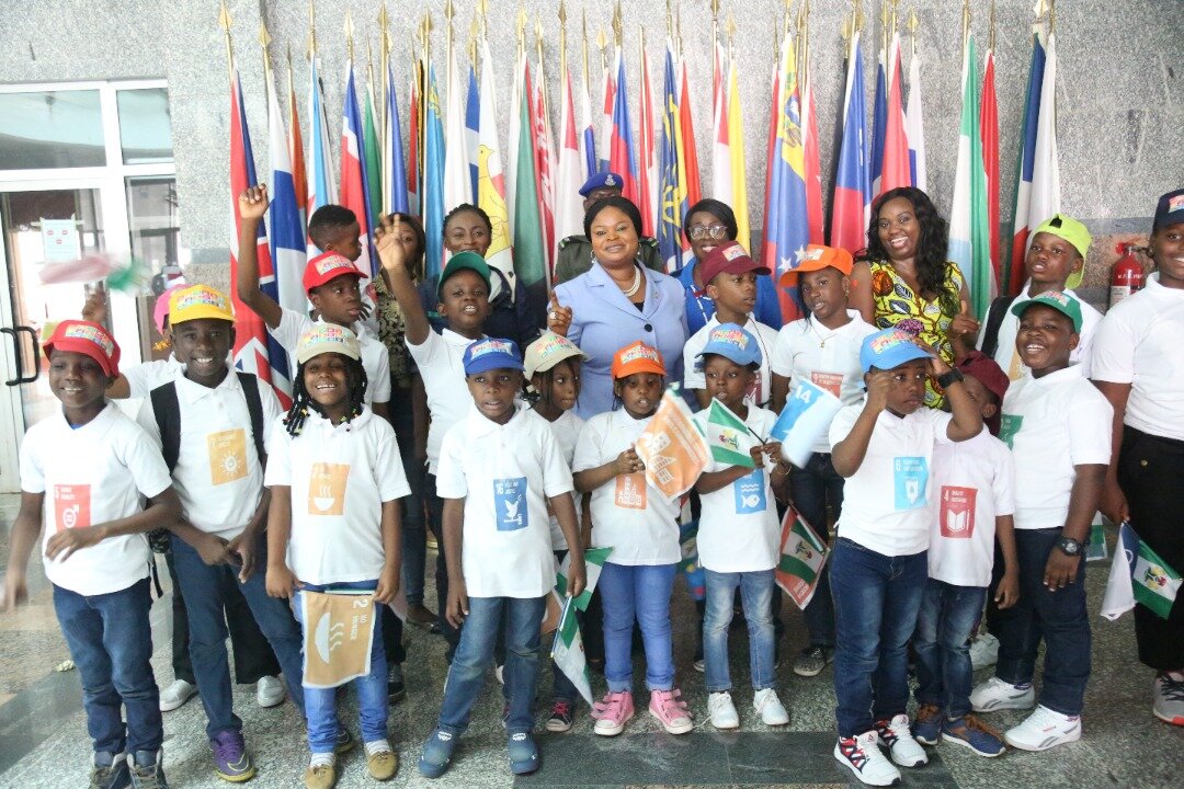 With children carrying SDG flags at a UN event